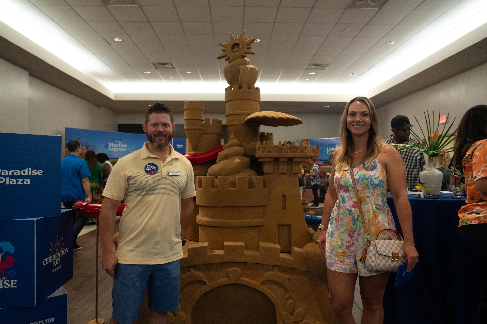 Noel  Chris McKee owners of Dancin at Sea Performance Cruises smile in front of Paradise Plaza Suncastle model