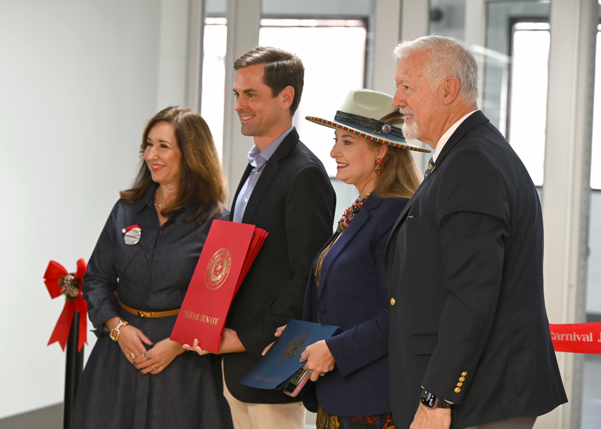 Texas State Senator Mayes Middleton and State Representative Terri Leo Wilson present certificate to Carnival Cruise Line